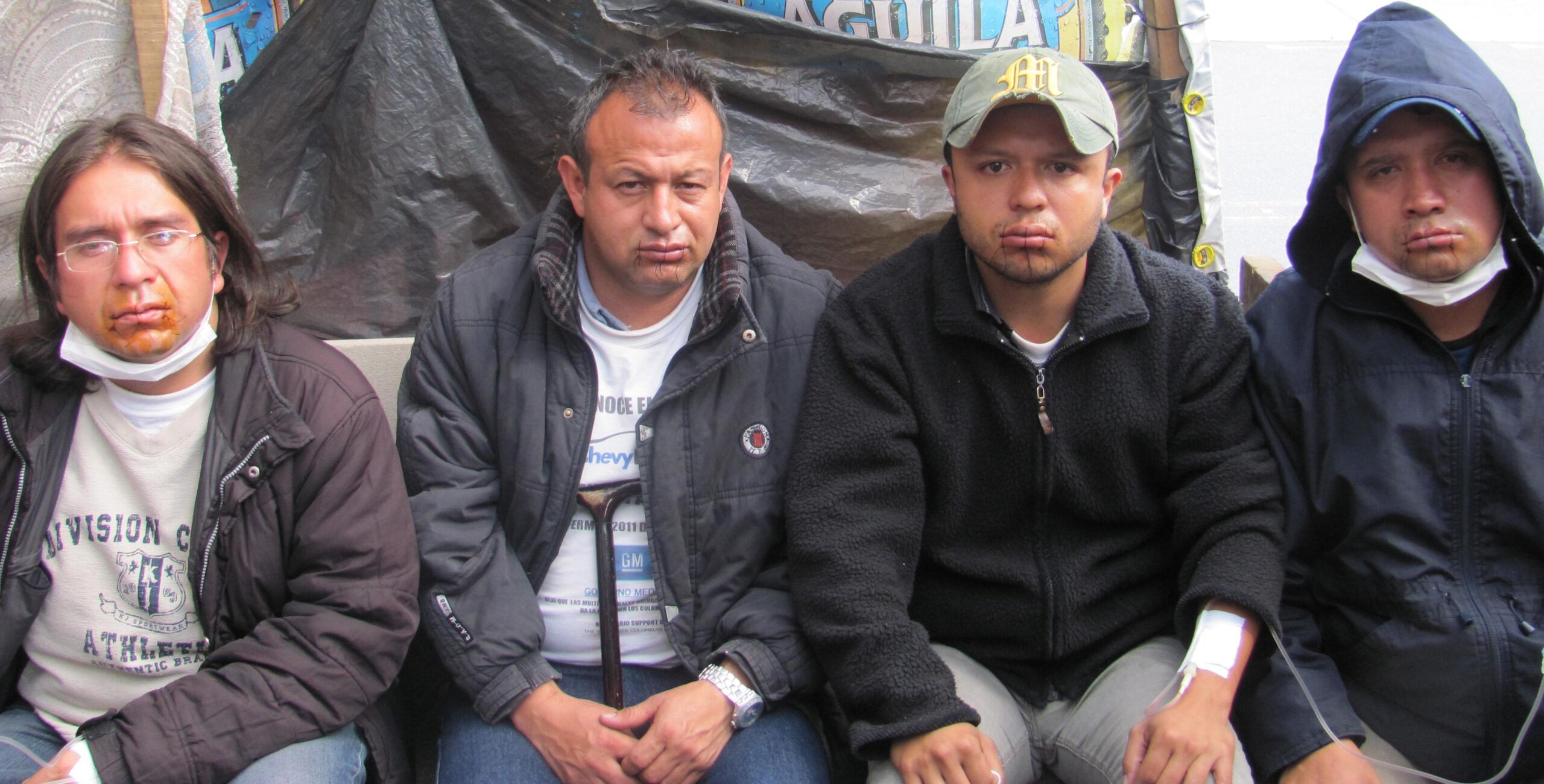 Ex-GM workers in Colombia sew shut mouths
