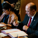 Rosa Pavanelli, PSI, and Valter Sanches, IndustriALL sign the agreement.