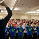 Congress delegates putting on red headbands in support of Korean trade unions, whose rights are under serious attacks.