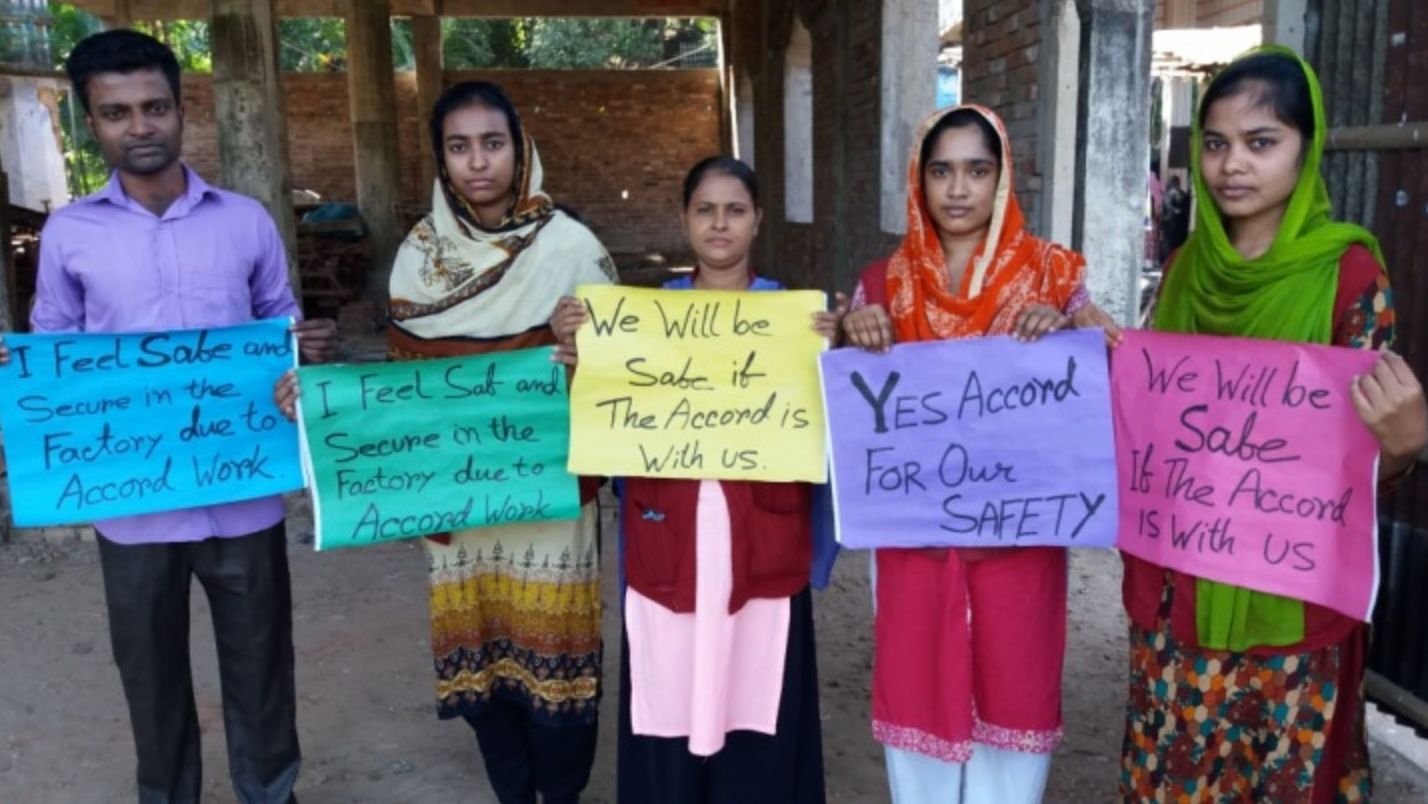 Garment workers in Chittagong, Bangladesh show their support for the Accord remaining in the country.
